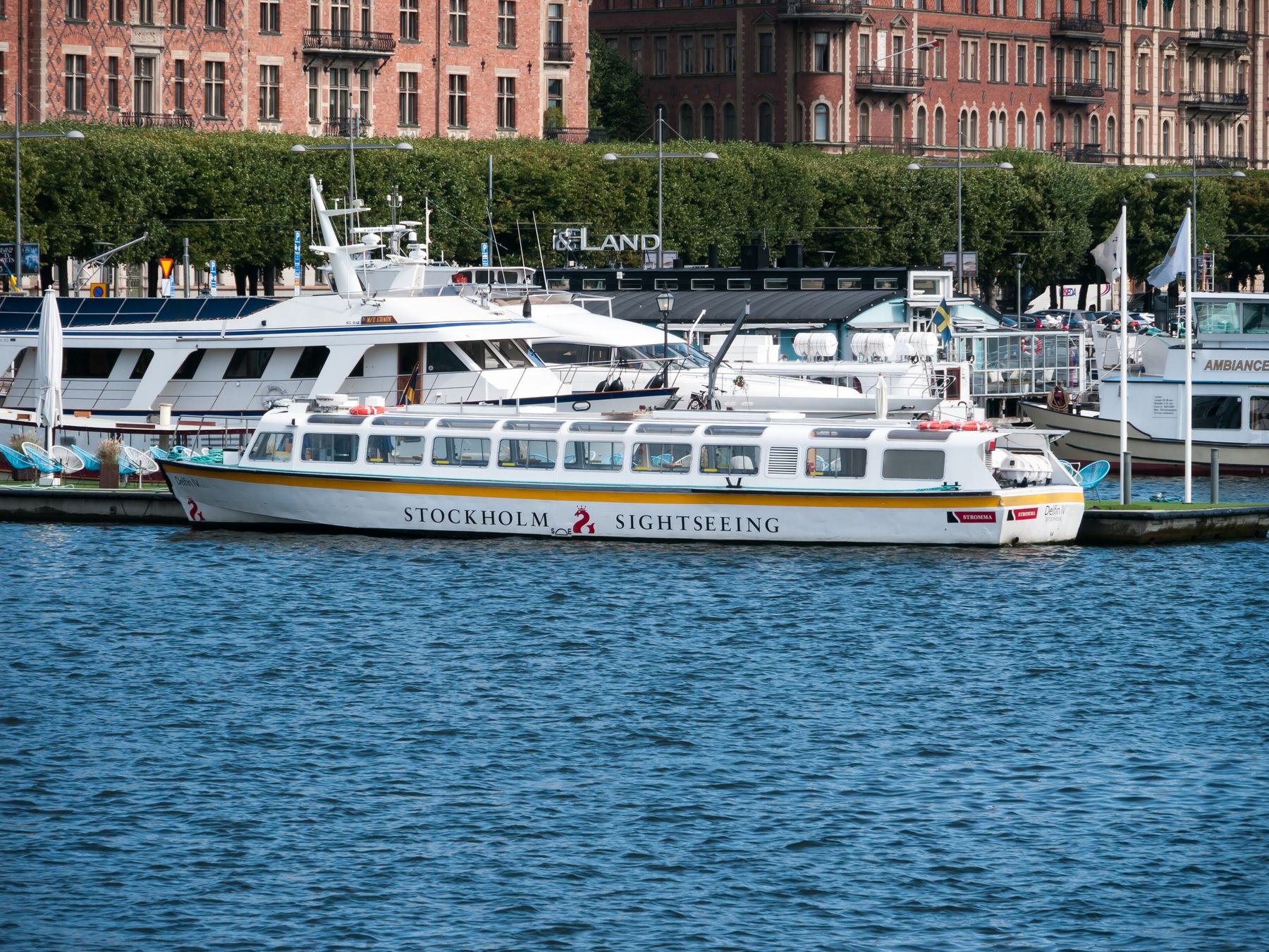 Sightseeing boat in Stockholm harbour in front of the waterfront buildings